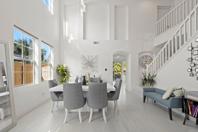 dining area with a high ceiling and a wealth of natural light