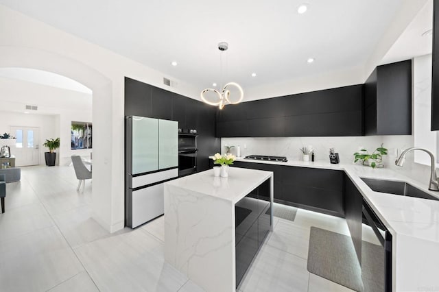 kitchen with sink, fridge, decorative light fixtures, dishwasher, and a kitchen island