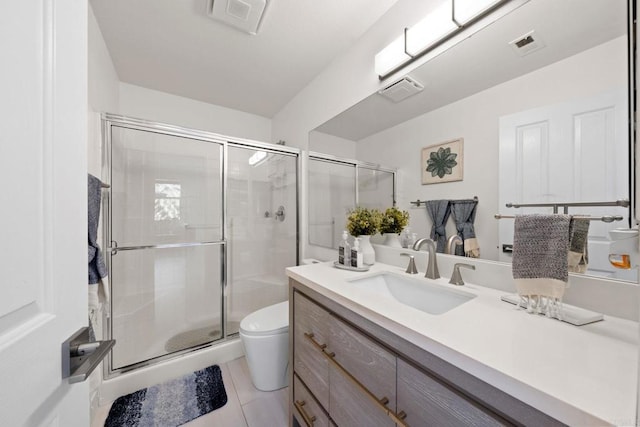 bathroom with toilet, a shower with door, tile patterned floors, and vanity