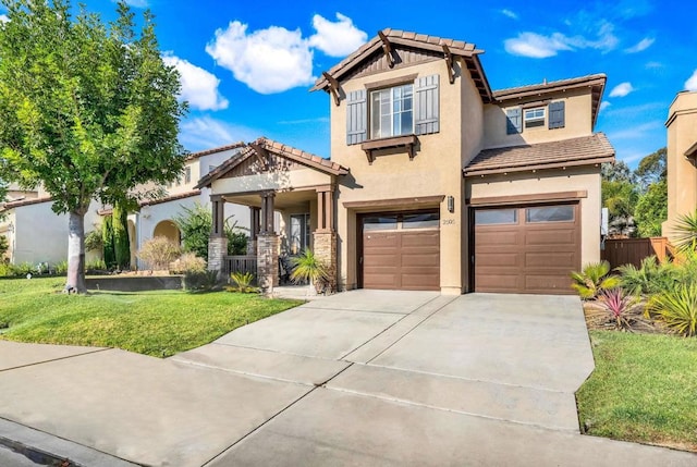 craftsman inspired home featuring a front yard and a garage