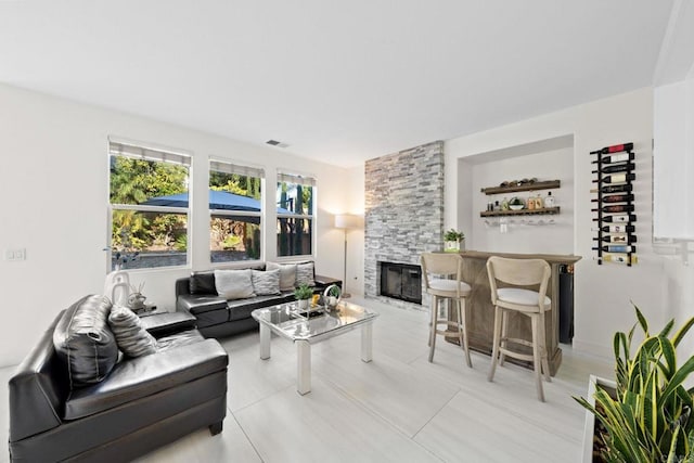 living room with a fireplace and tile patterned floors