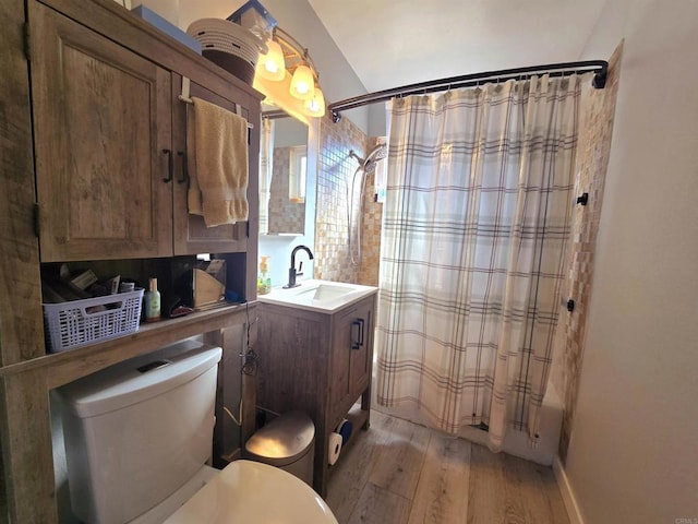 full bathroom with toilet, vanity, shower / tub combo, and hardwood / wood-style floors