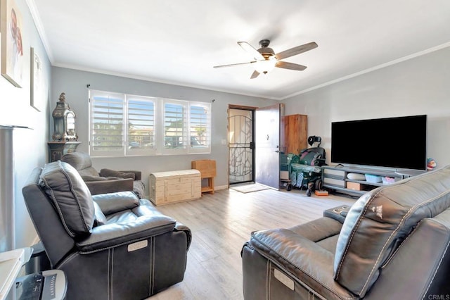 living room with ceiling fan, ornamental molding, and light hardwood / wood-style floors