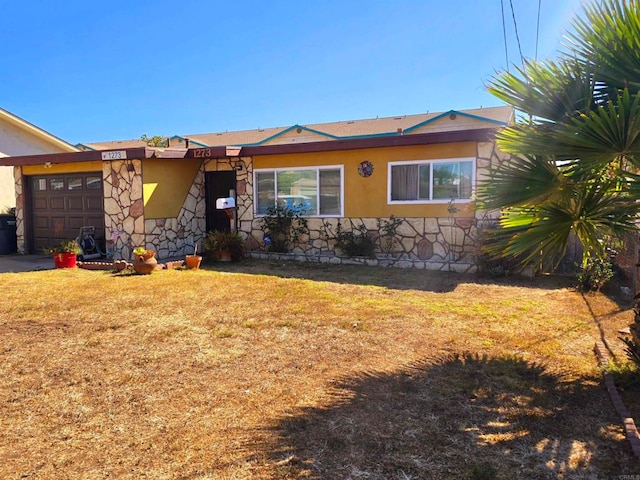 ranch-style house featuring a garage and a front lawn