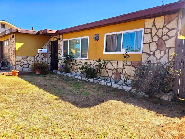 view of side of property with a yard