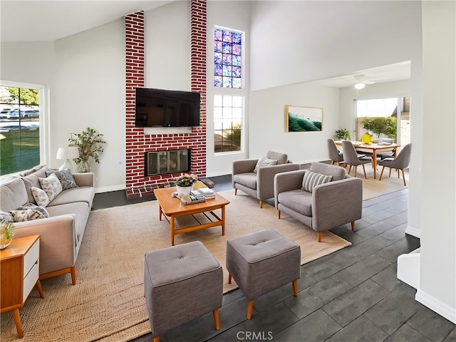 living room with high vaulted ceiling and a brick fireplace