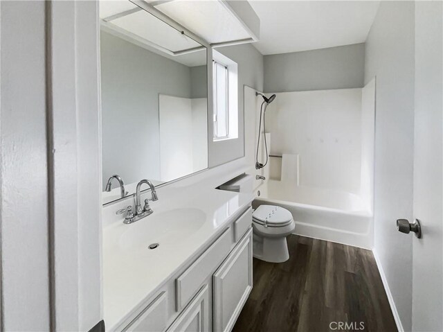 full bathroom featuring shower / bathtub combination, toilet, vanity, and hardwood / wood-style flooring