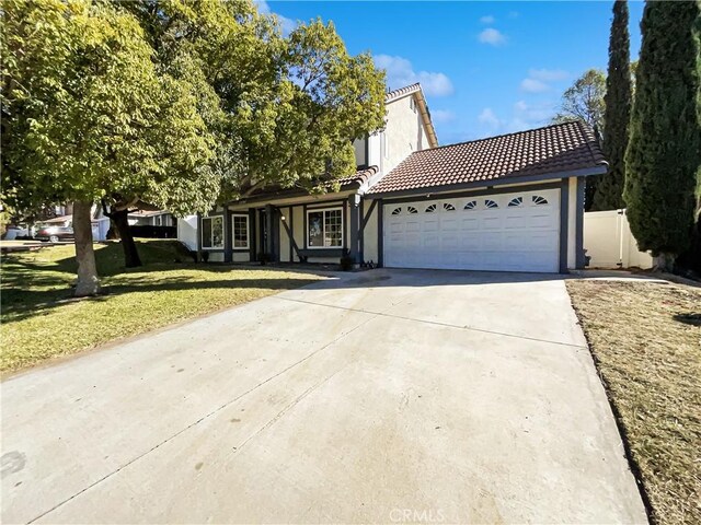 view of front of property featuring a front lawn and a garage