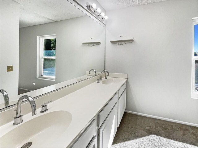 bathroom with vanity and a textured ceiling