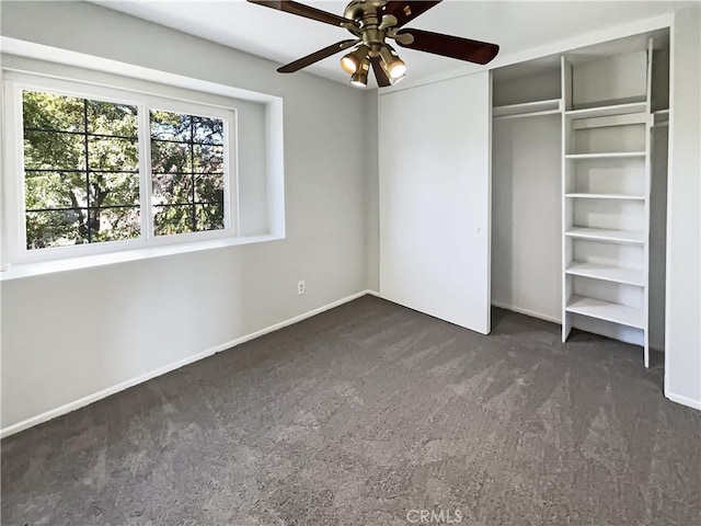 unfurnished bedroom featuring ceiling fan, a closet, and dark colored carpet