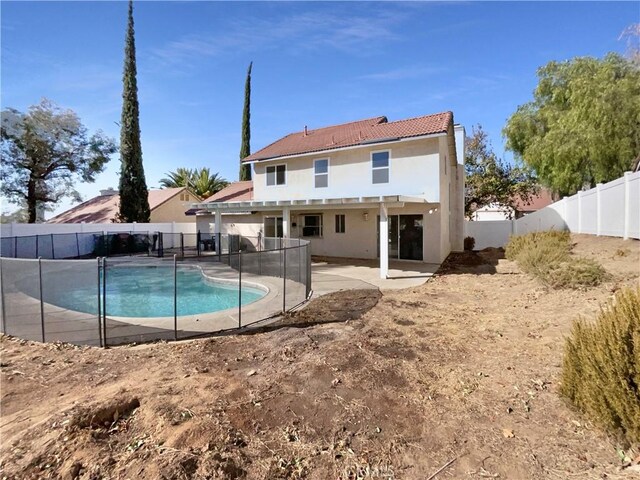 back of house with a patio area and a fenced in pool