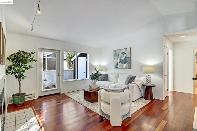 living room with lofted ceiling, dark hardwood / wood-style flooring, and baseboard heating