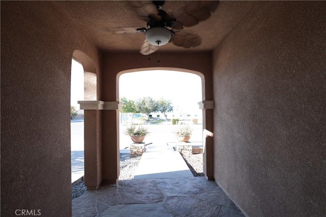 doorway with ceiling fan