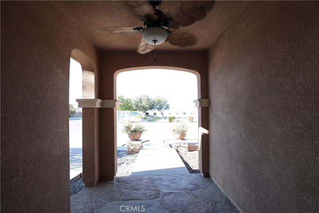 exterior space with ceiling fan