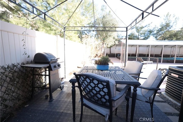 view of patio / terrace with central air condition unit, outdoor dining space, grilling area, and a fenced backyard