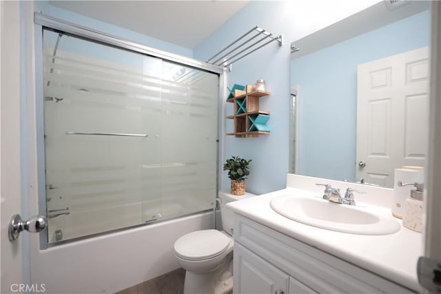 full bathroom featuring toilet, vanity, combined bath / shower with glass door, and wood finished floors