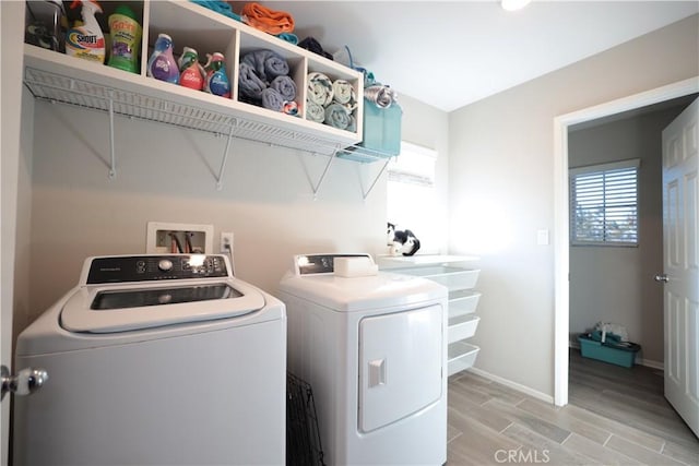 washroom with light hardwood / wood-style floors and independent washer and dryer