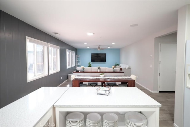 kitchen with recessed lighting, light wood finished floors, ceiling fan, light countertops, and baseboards