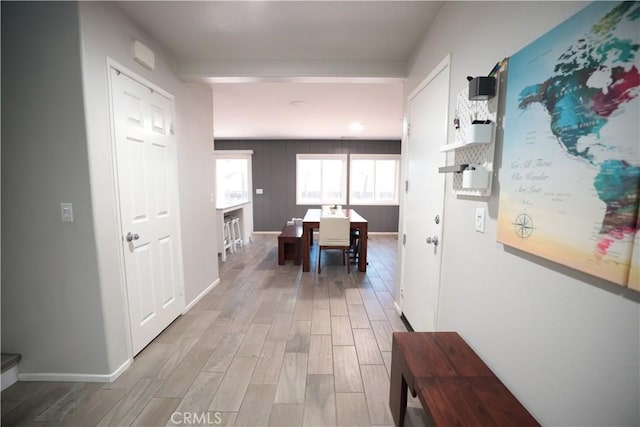 hall featuring baseboards and wood finished floors