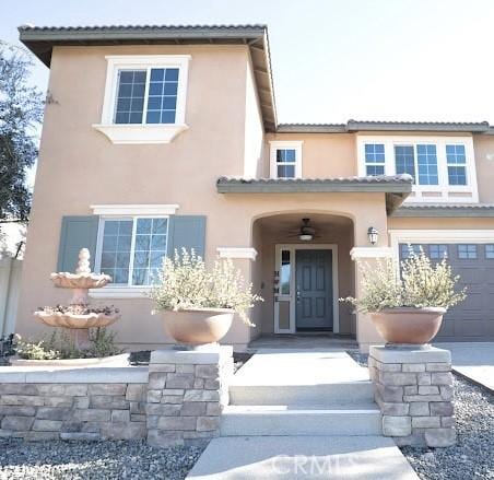 property entrance featuring stucco siding and a tiled roof