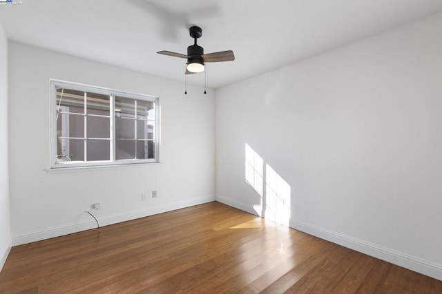 empty room featuring ceiling fan and hardwood / wood-style flooring