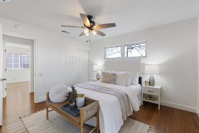 bedroom featuring a closet, ceiling fan, and dark hardwood / wood-style floors