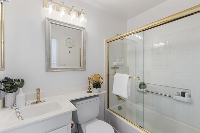 full bathroom featuring toilet, enclosed tub / shower combo, and vanity