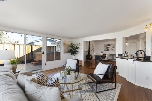 living room featuring sink and dark hardwood / wood-style floors