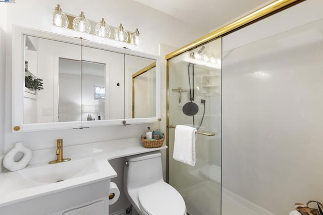 bathroom with toilet, an enclosed shower, and vanity