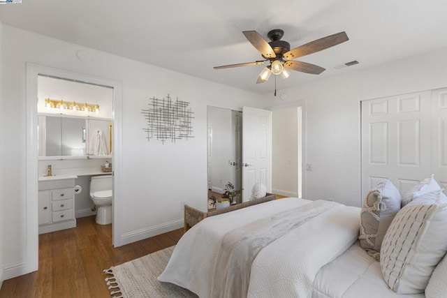 bedroom featuring connected bathroom, ceiling fan, and dark hardwood / wood-style floors