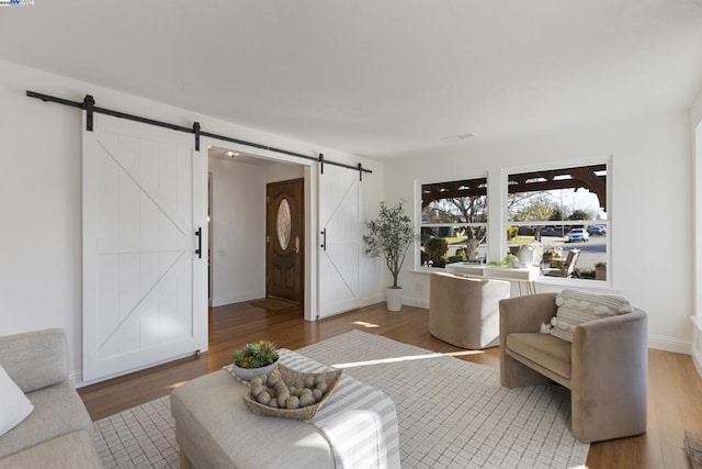 living room featuring hardwood / wood-style flooring and a barn door