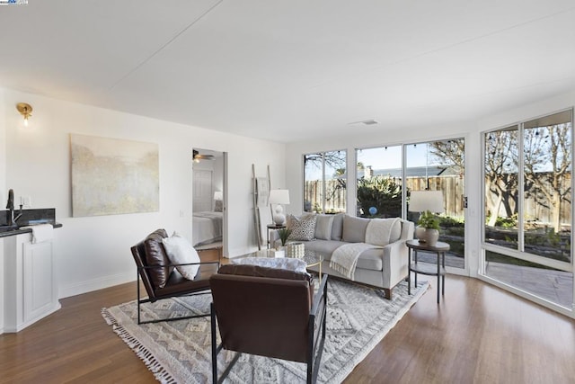 living room with ceiling fan and dark hardwood / wood-style flooring