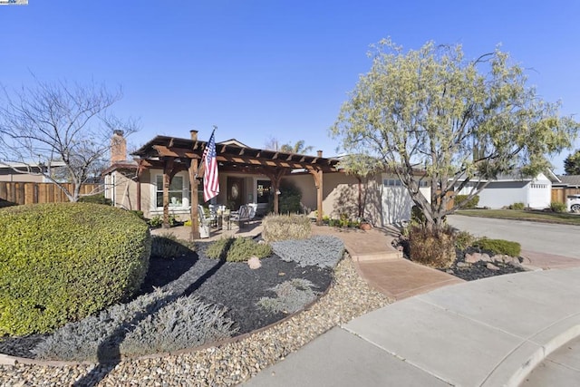 view of front of property with a patio area and a pergola