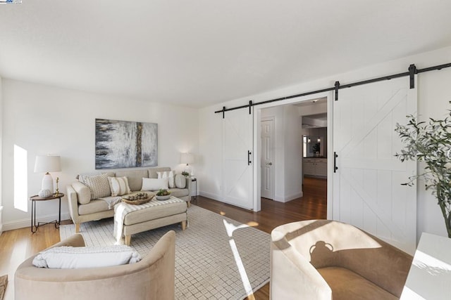 living room with hardwood / wood-style floors and a barn door