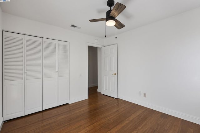 unfurnished bedroom with a closet, ceiling fan, and dark hardwood / wood-style floors