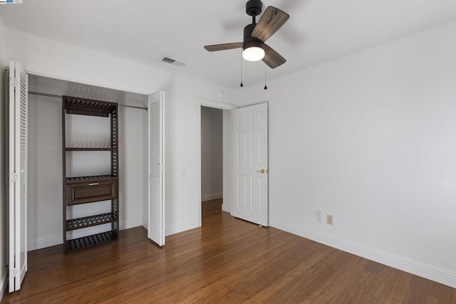 unfurnished bedroom with a closet, ceiling fan, and dark hardwood / wood-style floors