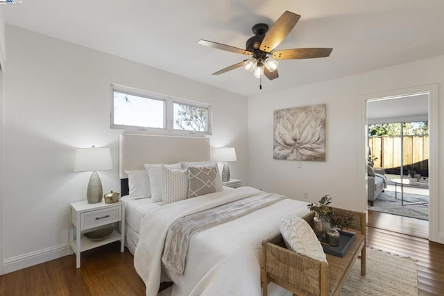 bedroom featuring ceiling fan, dark hardwood / wood-style flooring, and access to outside