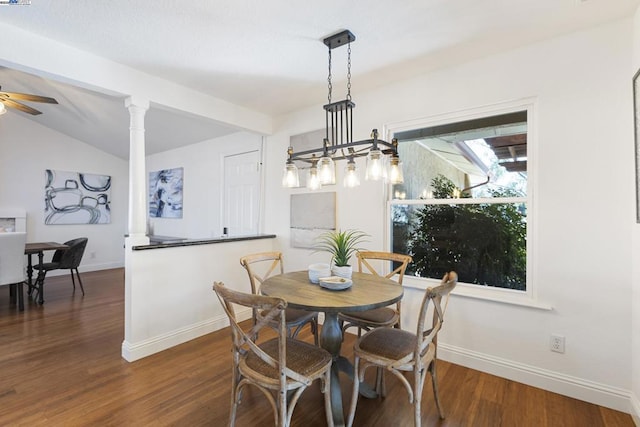 dining space with ornate columns, lofted ceiling with beams, dark hardwood / wood-style flooring, and ceiling fan