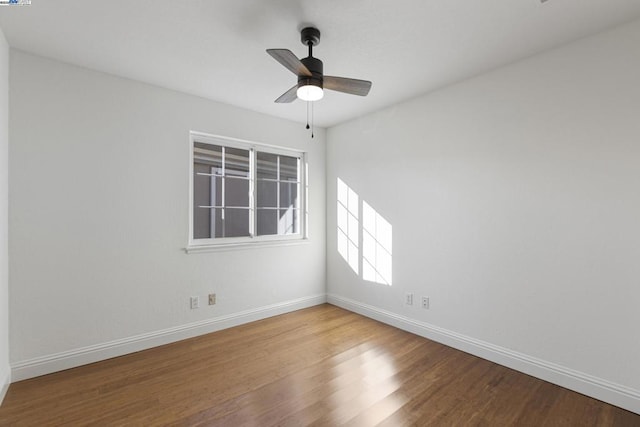 empty room featuring ceiling fan and hardwood / wood-style floors