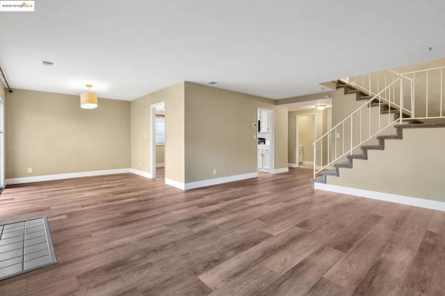 unfurnished living room with hardwood / wood-style floors