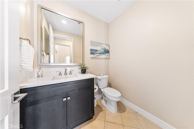 bathroom featuring vanity, tile patterned flooring, and toilet