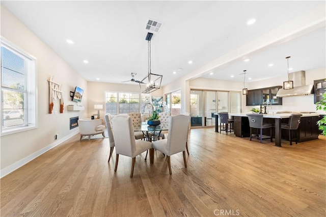 dining area featuring ceiling fan and light hardwood / wood-style flooring