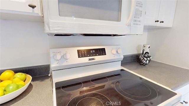 room details featuring white appliances and white cabinets