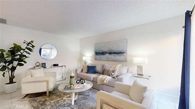 living room featuring light tile patterned floors and a textured ceiling