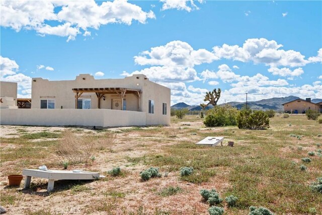 back of property with a mountain view