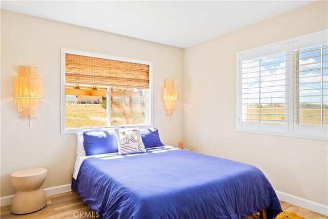 bedroom with hardwood / wood-style flooring