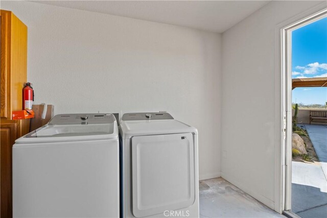 clothes washing area with washer and dryer and plenty of natural light