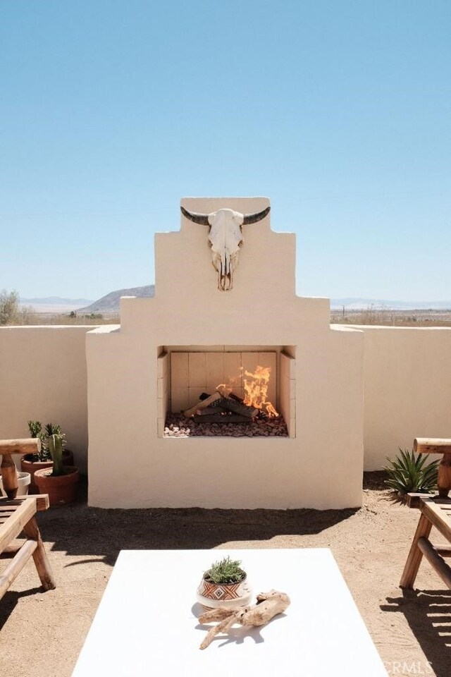 view of patio featuring an outdoor fireplace