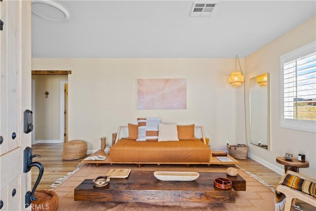 sitting room with wood-type flooring