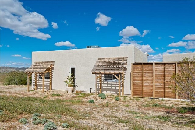 rear view of property featuring an outdoor structure